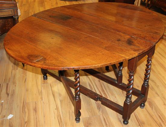 An 18th century walnut oval gateleg dining table, extended 4ft 9in.